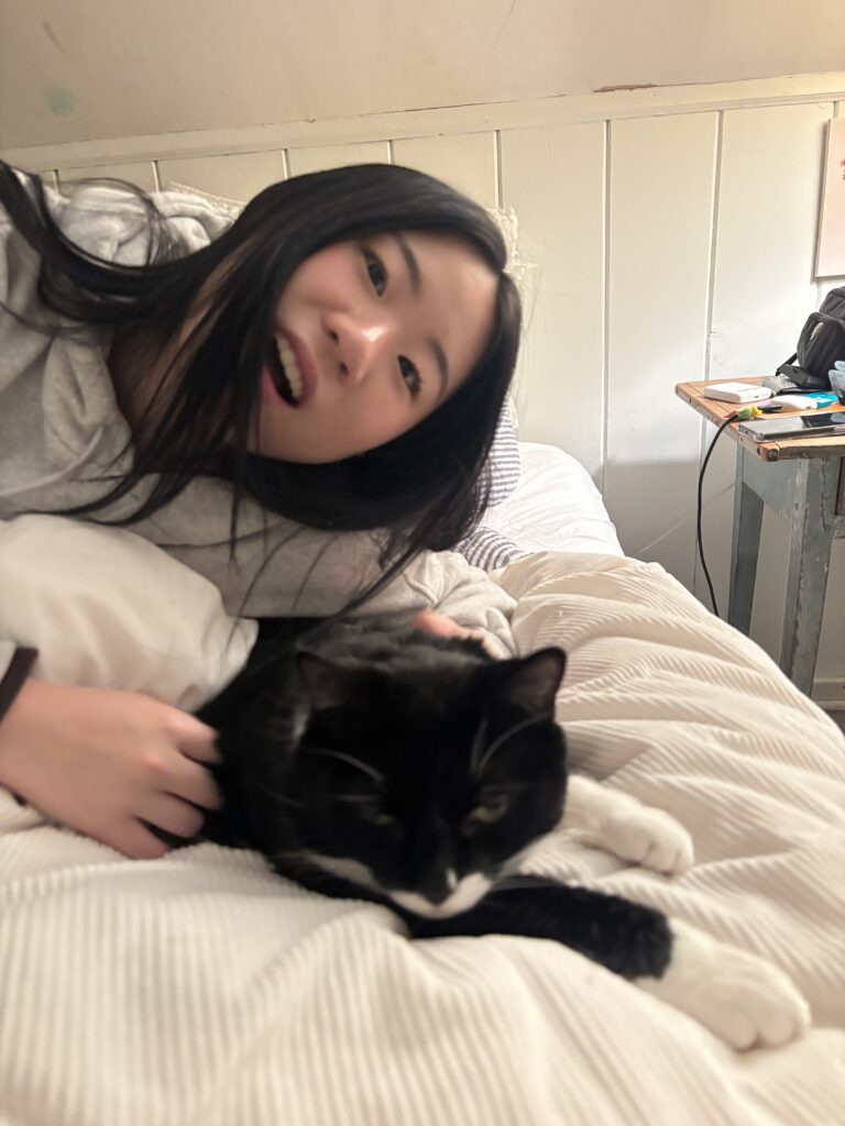 International student relaxes with the host family’s cat