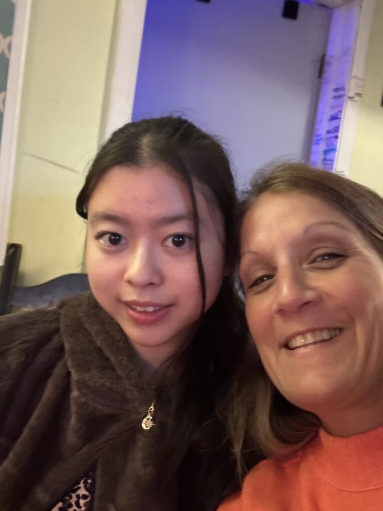 International student smiles for a selfie with a trusted local adult