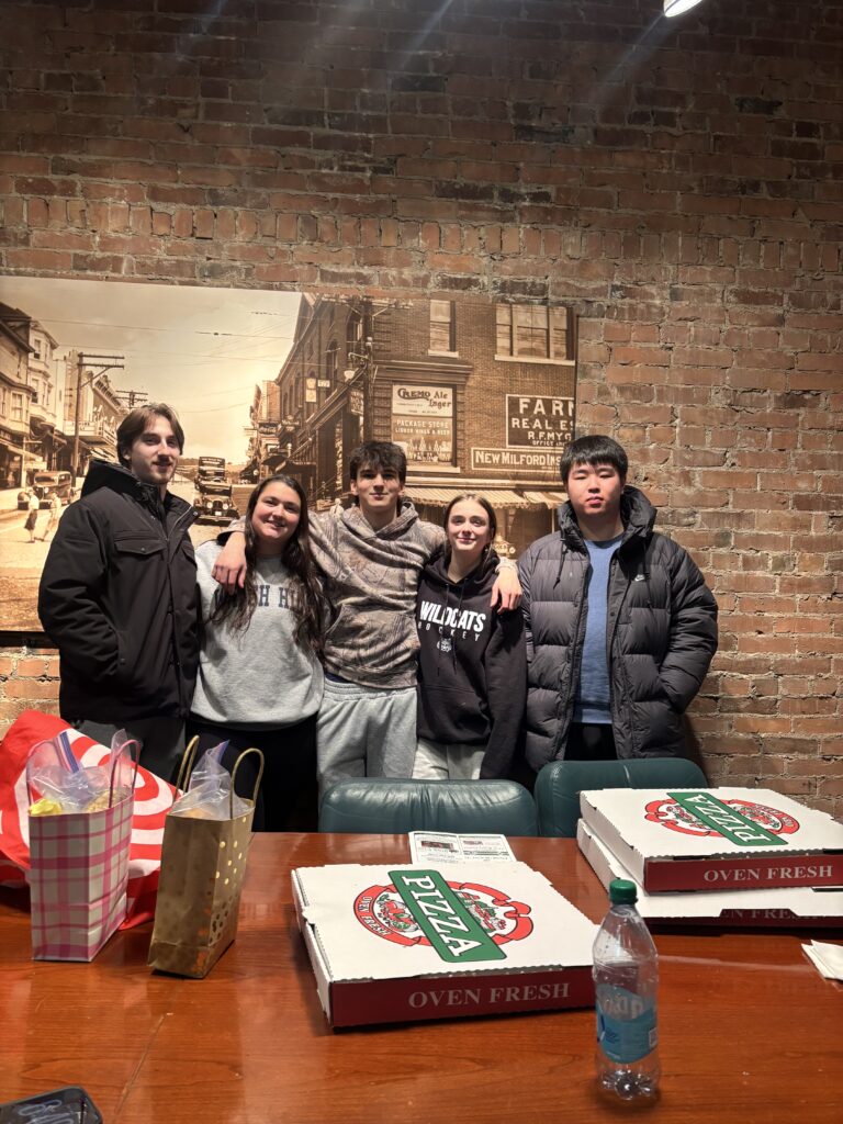 International students share a pizza night with friends during boarding school break homestays in the U.S.
