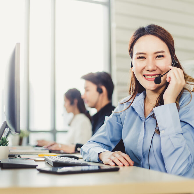 Beautiful,Woman,Operator,With,Headset,Looking,At,The,Camera,While