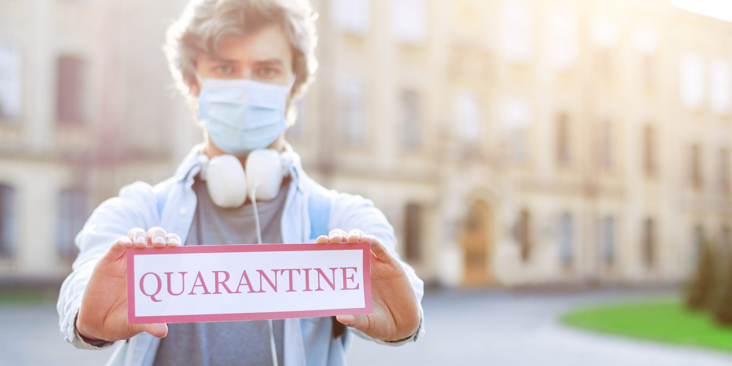 Young,Man,In,Medical,Mask,Standing,Near,Closed,For,Quarantine