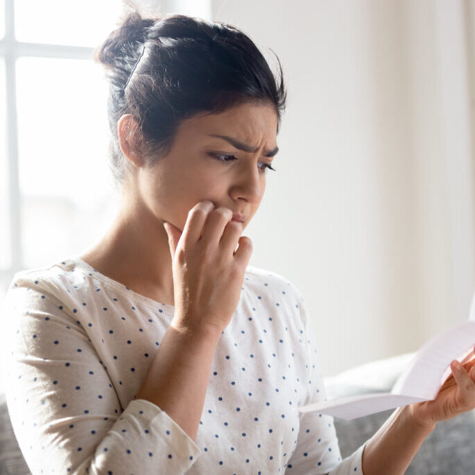 Worried,Indian,Millennial,Girl,Read,Post,Correspondence,Thinking,About,Unpleasant